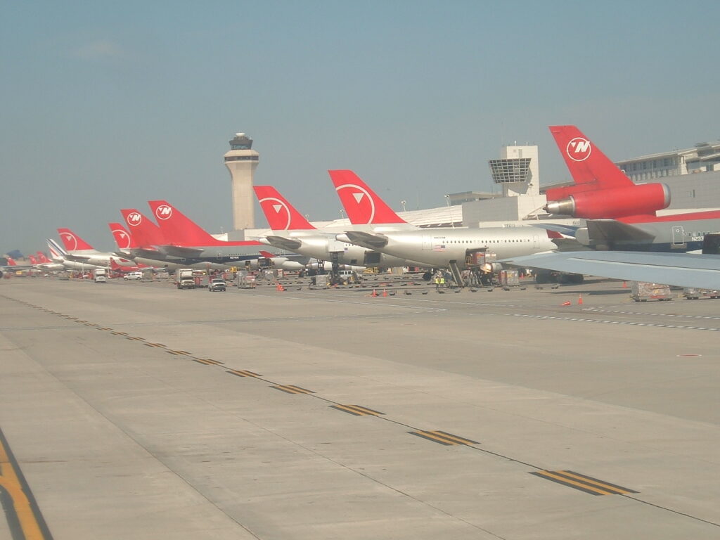 During the pushback of our 757-251 for flight 845 to Minneapolis-St. Paul.  See the assortment of Northwest tails from DC-10, 747s, A330s and something from Air France in the distance.