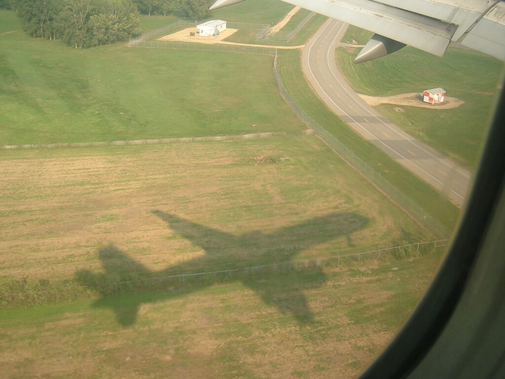 The aircraft chasing the shadow effect as we make our get closer to the runway for a Minneapolis-St. Paul MSP runway 12R landing.